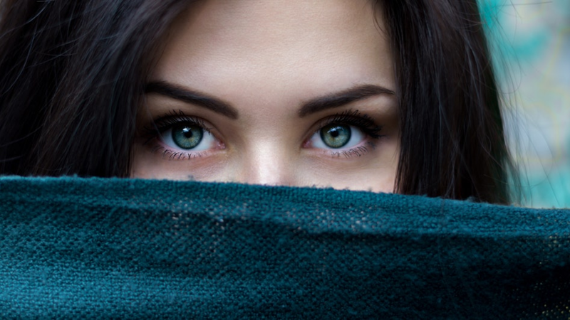 Striking eyes framed in teal